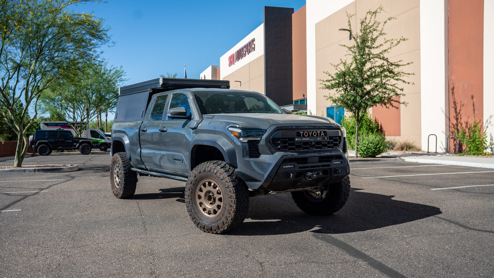 The 2024 Toyota Tacoma Trailhunter parked outside SDHQ Off-Road after the Banks 26012 boost tube install