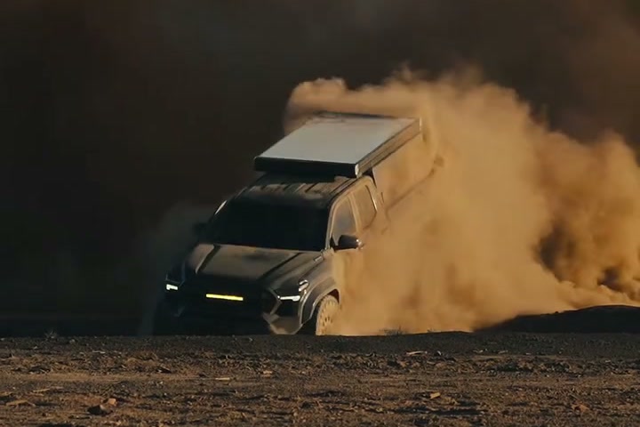 2024 Toyota Tacoma Trailhunter on 37-inch Toyo RT Pros and 74Weld gen2 portal axles throwing black volcanic dust across the open flat at Cinders OHV on Coconino National Forest land north of Sunset Crater, Arizona