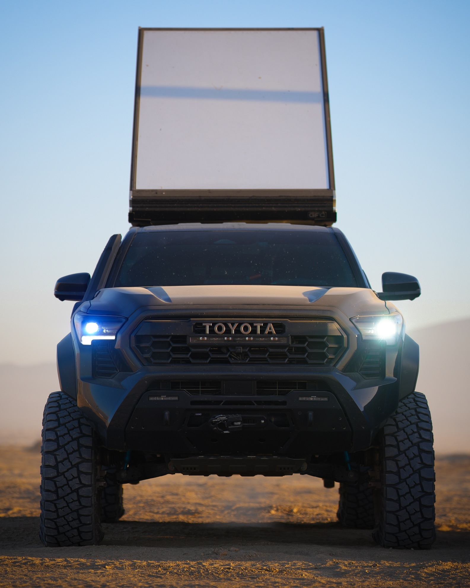 Trailhunter at dusk in the desert with GFC camper deployed