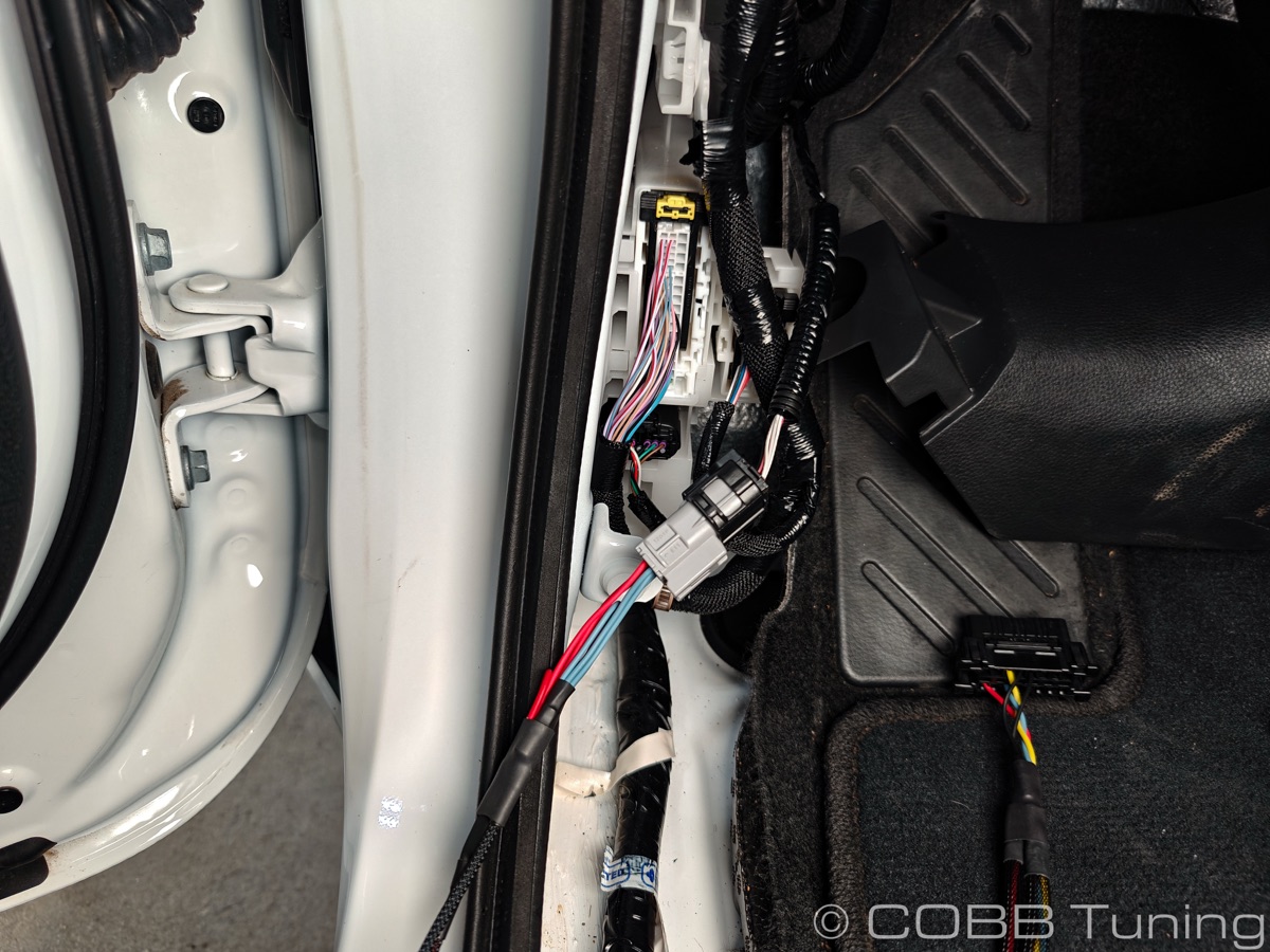 Bypass harness connected behind the kick panel