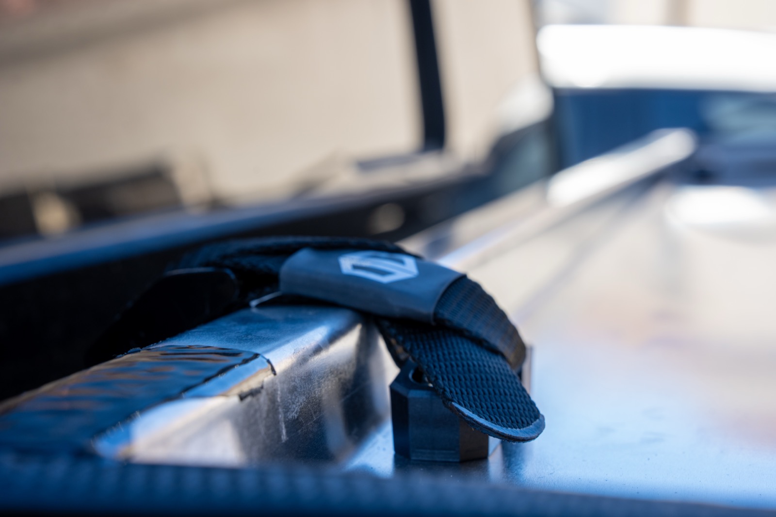 Tie-down strap through the anchor plate securing the folded Switchback 2.0 stack