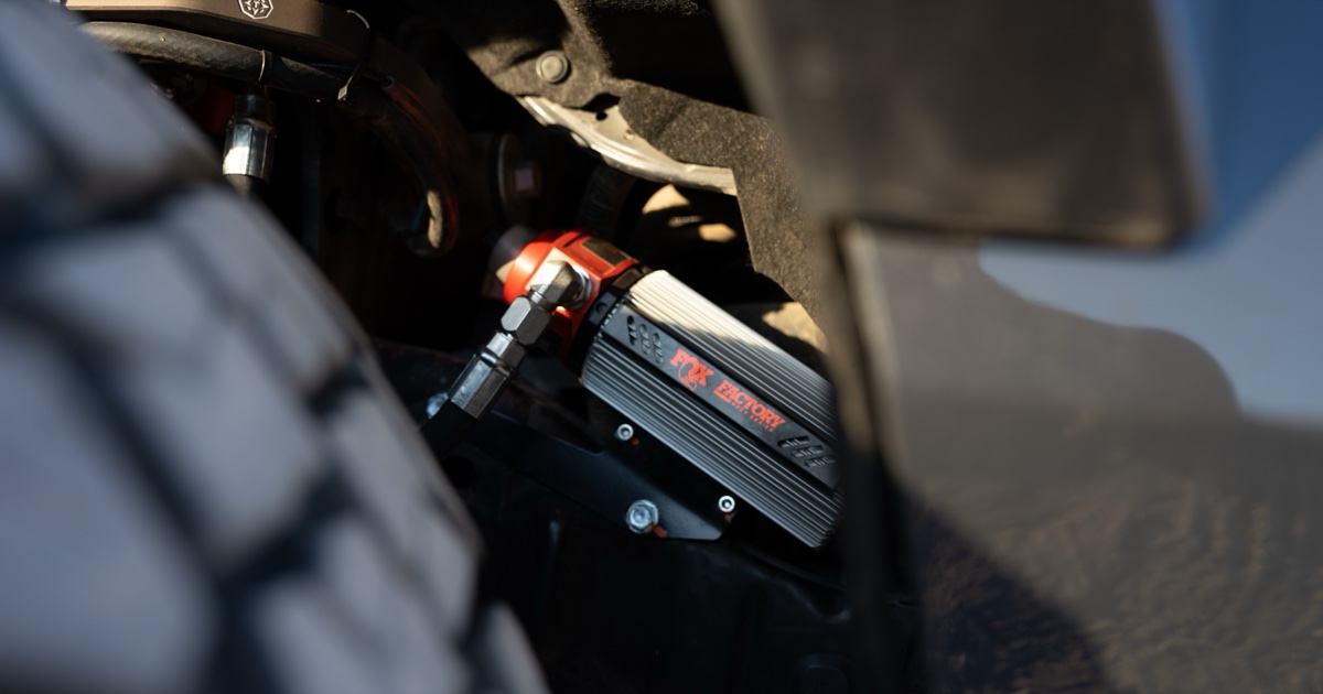 Fox Factory Race 3.2 reservoir and red Live Valve solenoid mounted on my Tacoma at golden hour, 74Weld portal hardware in frame