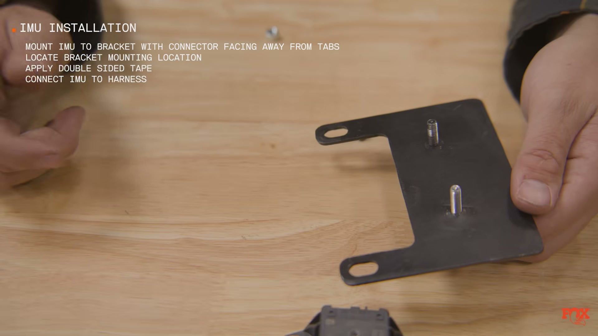 Fox Live Valve IMU mounting bracket with installation instructions visible — source: Fox Racing