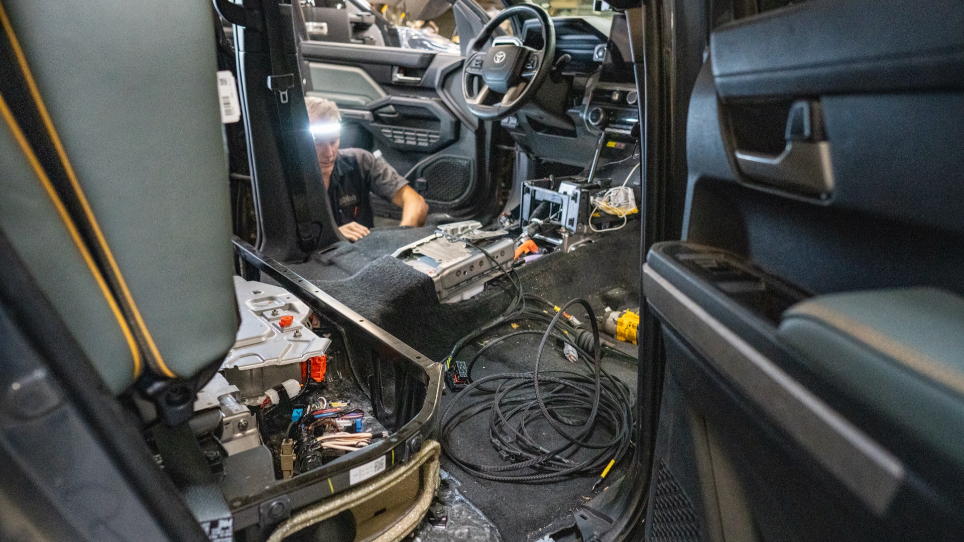 Center console of my Tacoma opened up for the CAN tap and IMU mounting during the SDHQ install, hybrid battery exposed under the rear seat — photo: SDHQ Off Road