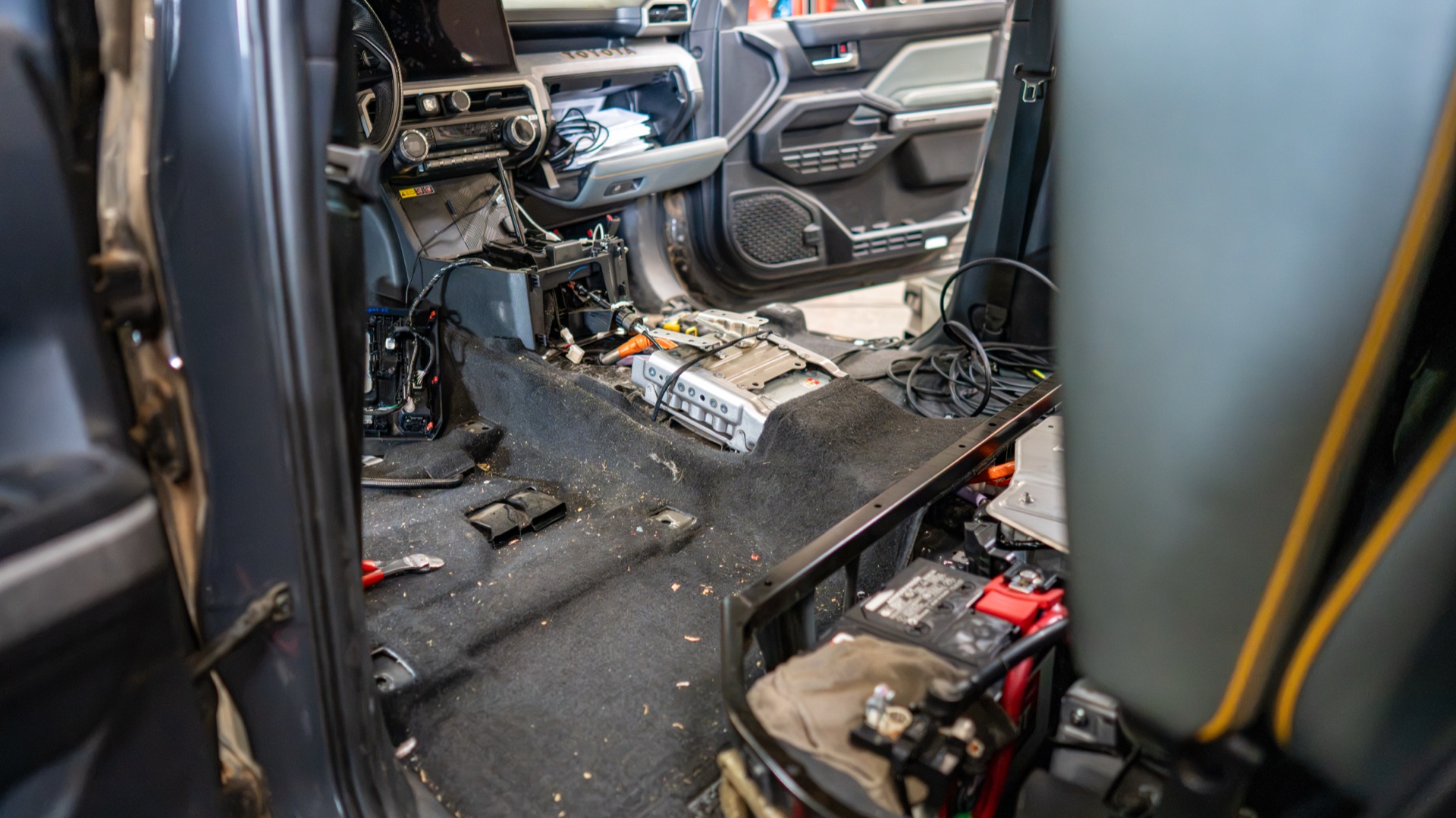 Center console of my Tacoma stripped to its frame for the IMU mount, 12-volt battery and Fox harness exposed — photo: SDHQ Off Road
