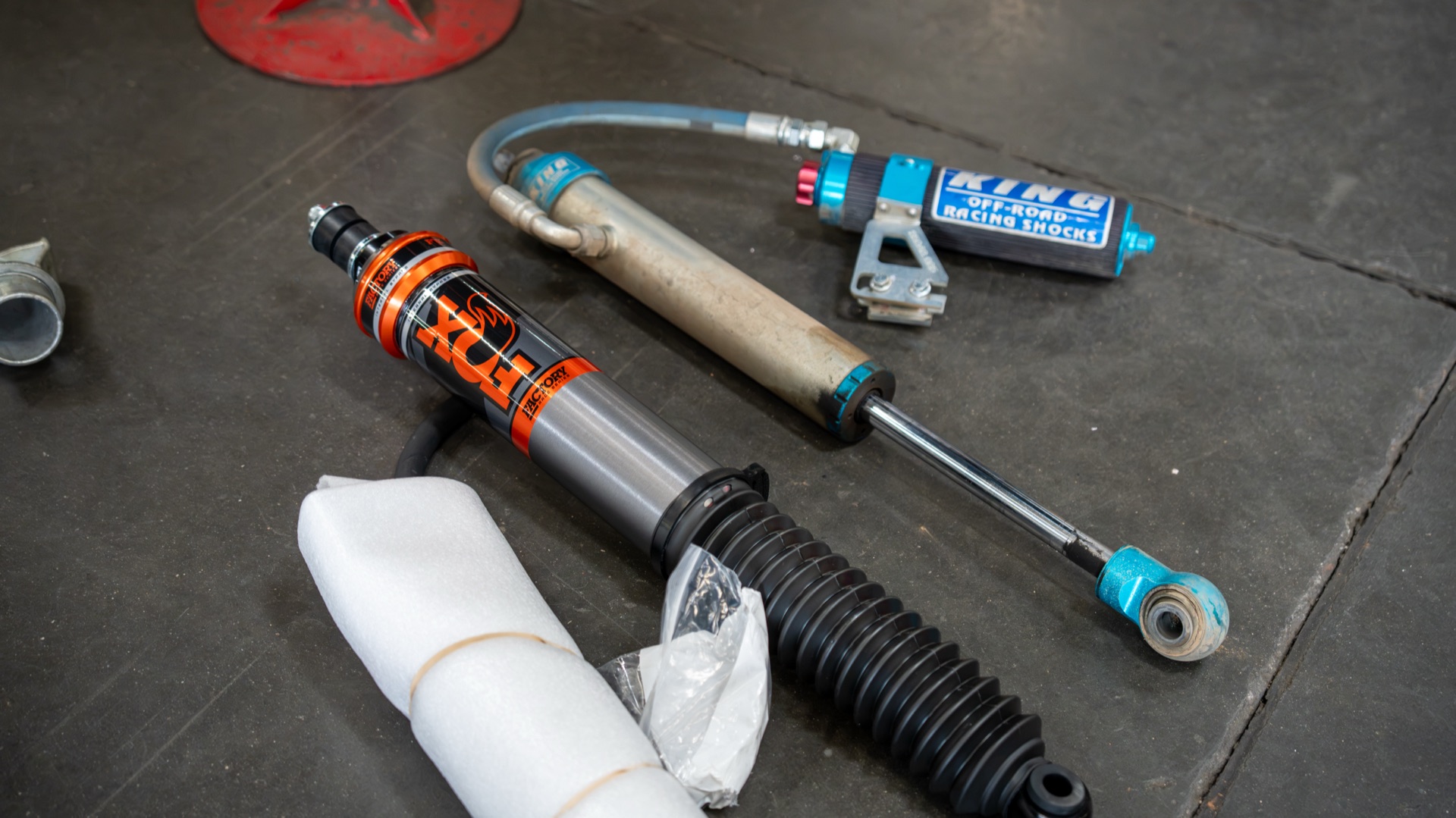 New Fox 3.2 Live Valve rear shock on the shop floor next to the custom-valved King it replaced — photo: SDHQ Off Road