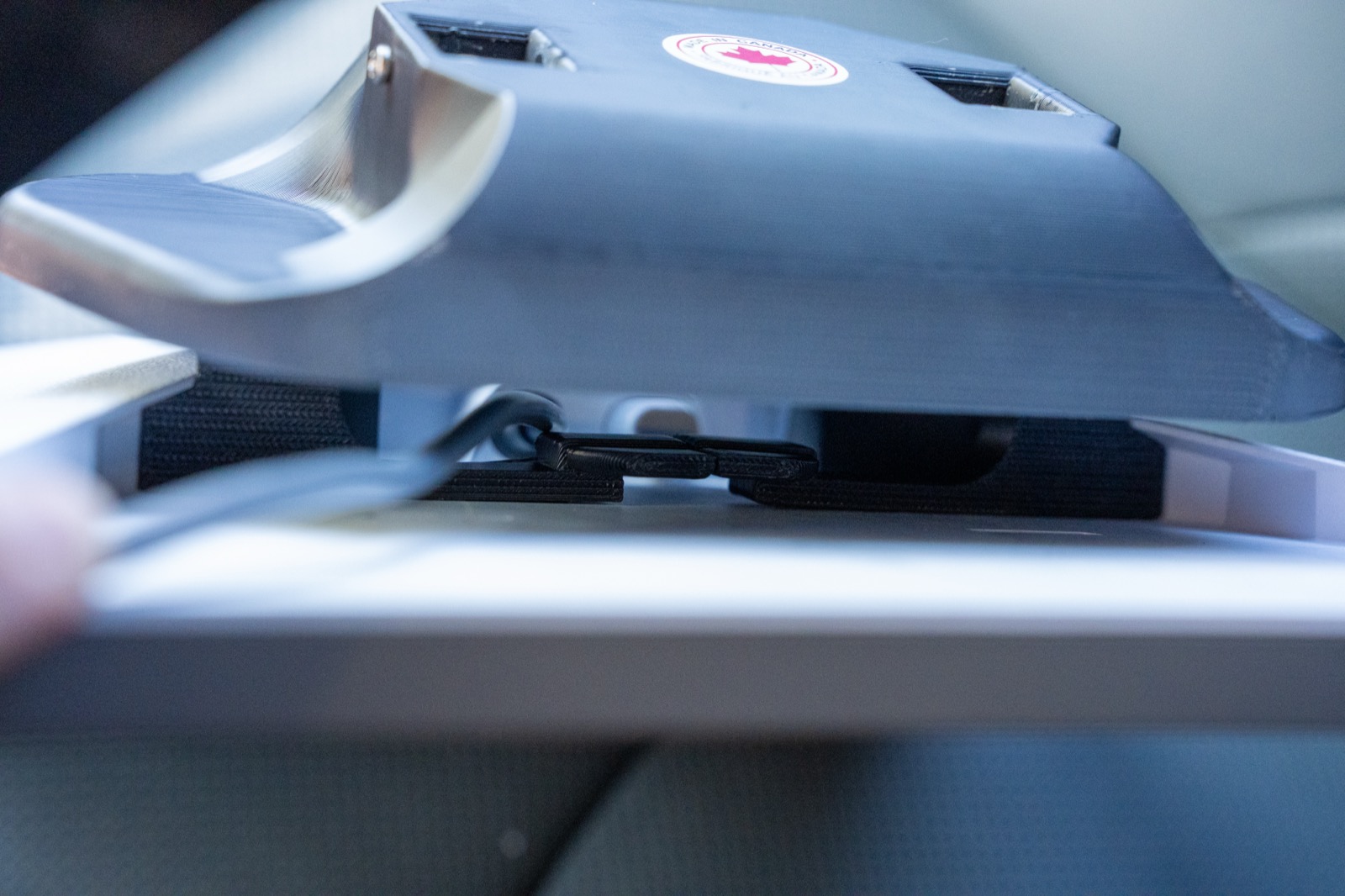 Broken Rover bracket clipped onto the back of a Starlink Mini, showing the 3D printed clips that grab the dish
