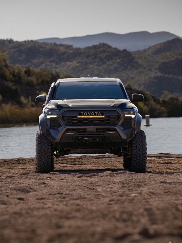 Tacoma parked at a mountain lake at dusk