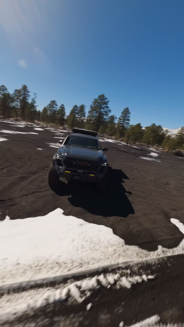 Tacoma crossing an open high-desert landscape