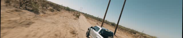 Trophy truck kicking up dust in desert chase