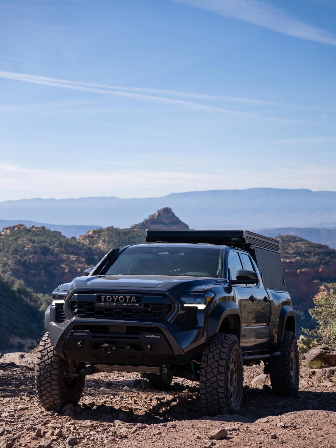 Tacoma Trailhunter on portal axles at a Sedona canyon overlook with GFC camper