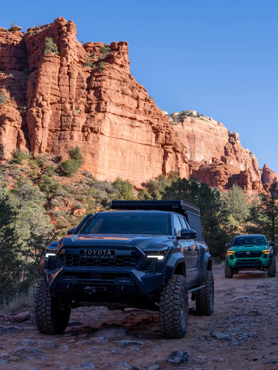 Tacoma and JKU side by side on Sedona red rocks