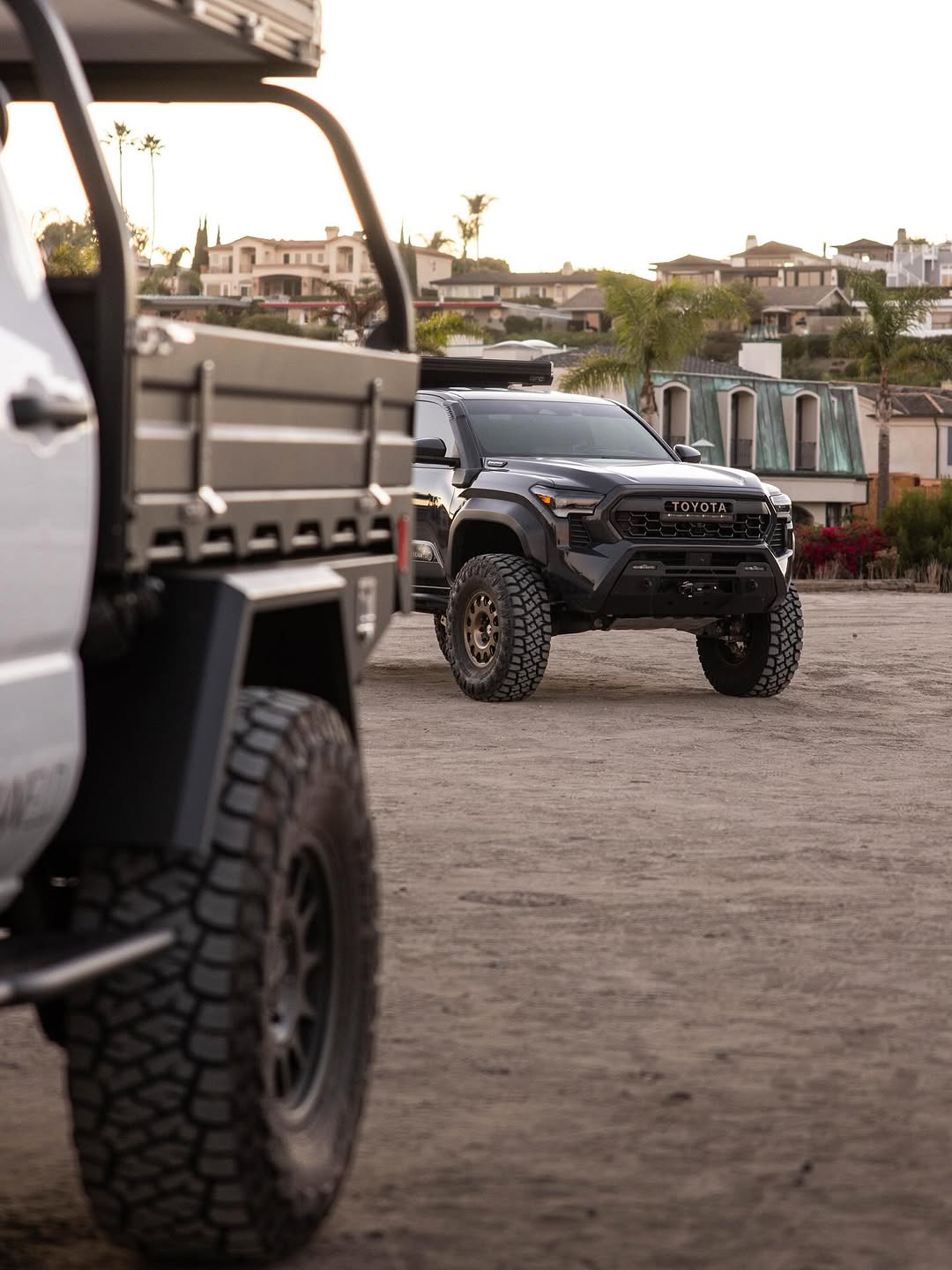 Tacoma parked on beach at sunset