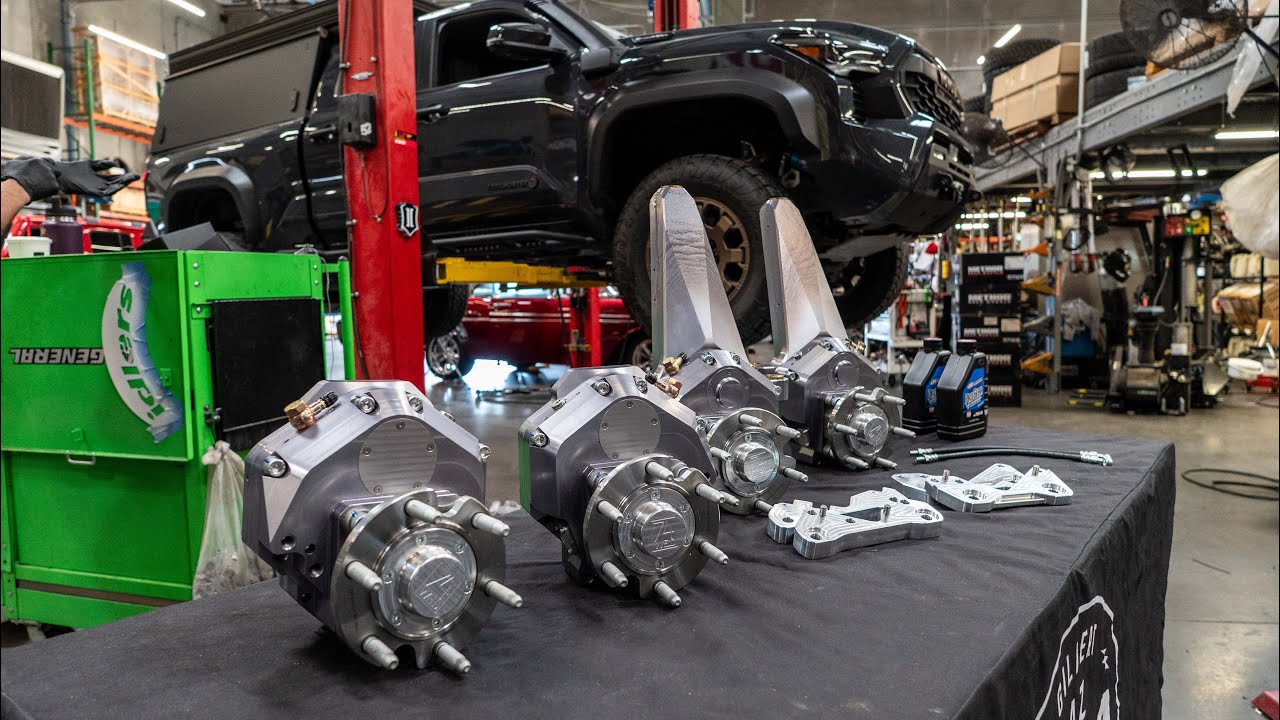 74Weld portal axle install video: portal boxes laid out with the Tacoma on a lift